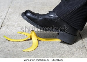 stock-photo-businessman-about-to-slip-and-fall-on-a-banana-skin-56991727