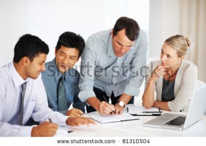 stock-photo-mature-male-leader-with-multi-ethnic-business-team-working-together-in-board-room-81310504